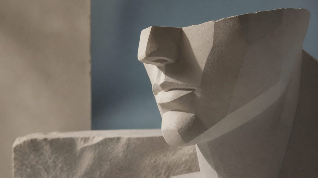Abstract sculptural face form with smooth contours lit from the side.